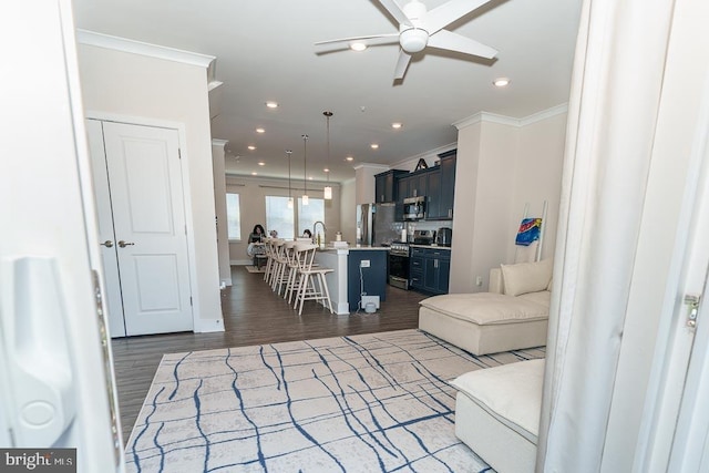 living room featuring dark wood-type flooring, recessed lighting, and crown molding