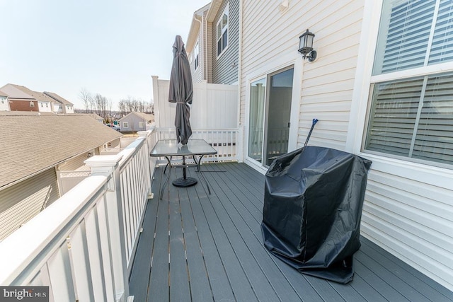 deck with a residential view and grilling area