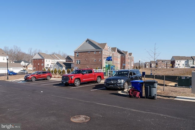 uncovered parking lot with a residential view