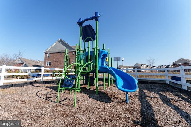 community play area featuring a residential view and fence