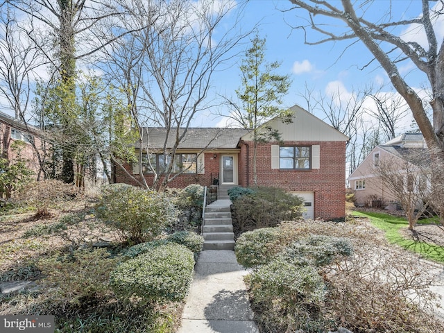 view of front of property featuring a garage, driveway, and brick siding