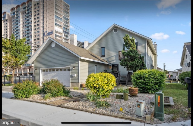 view of front of house with a garage and fence