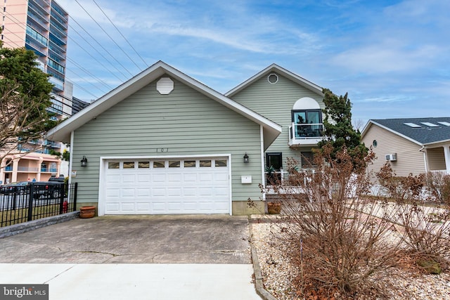 traditional-style home with an attached garage, fence, and concrete driveway