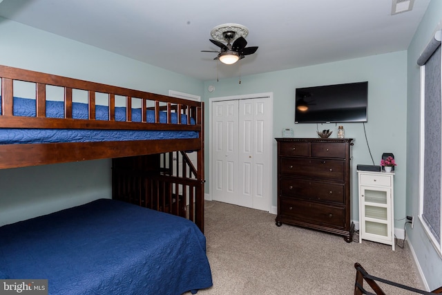 bedroom featuring light carpet, baseboards, visible vents, and a ceiling fan