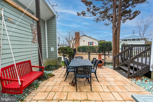 view of patio with fence and outdoor dining area