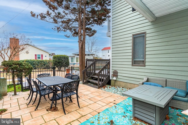 view of patio featuring outdoor dining space and fence