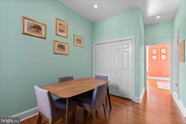 dining area with light wood-style floors, baseboards, and recessed lighting