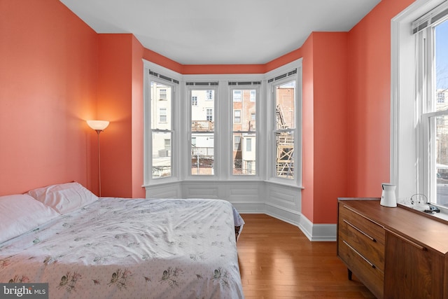 bedroom featuring wood finished floors and baseboards