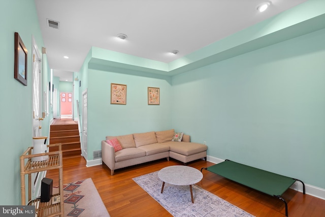 living room featuring recessed lighting, visible vents, stairway, wood finished floors, and baseboards