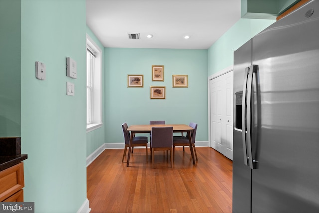 dining area with recessed lighting, wood finished floors, visible vents, and baseboards