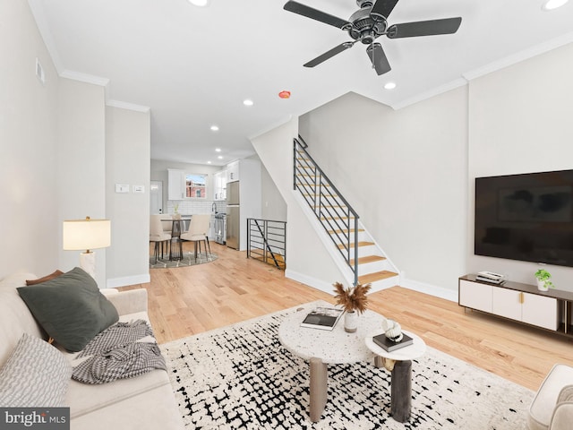 living room featuring light hardwood / wood-style floors and crown molding