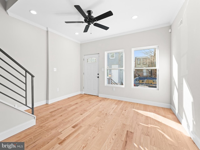 entryway with ceiling fan, ornamental molding, and light hardwood / wood-style floors