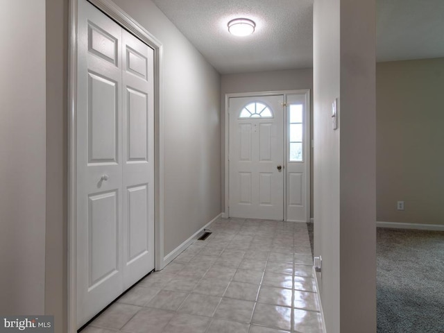 doorway with a textured ceiling