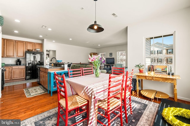 dining area with hardwood / wood-style flooring and sink