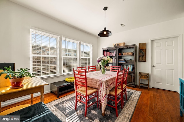 dining space with dark wood-type flooring