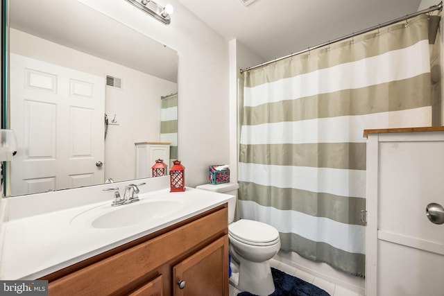 bathroom with tile patterned floors, vanity, and toilet