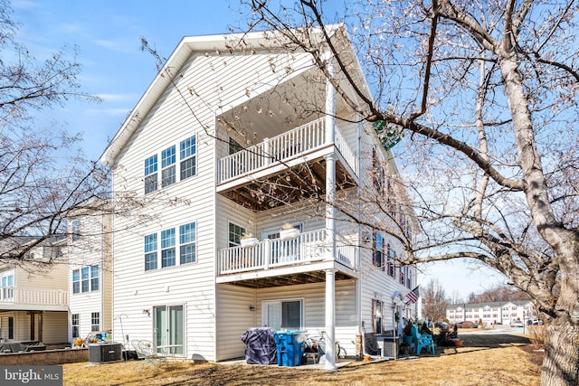 back of house featuring central AC and a balcony