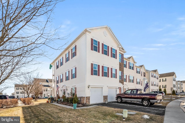 view of home's exterior with a garage and a yard