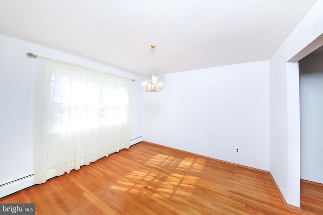 unfurnished room with a notable chandelier, a baseboard radiator, and wood-type flooring