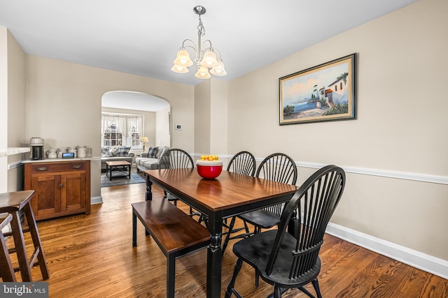 dining area featuring light hardwood / wood-style flooring and a notable chandelier