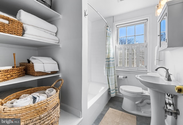 bathroom featuring shower / bathtub combination with curtain and toilet