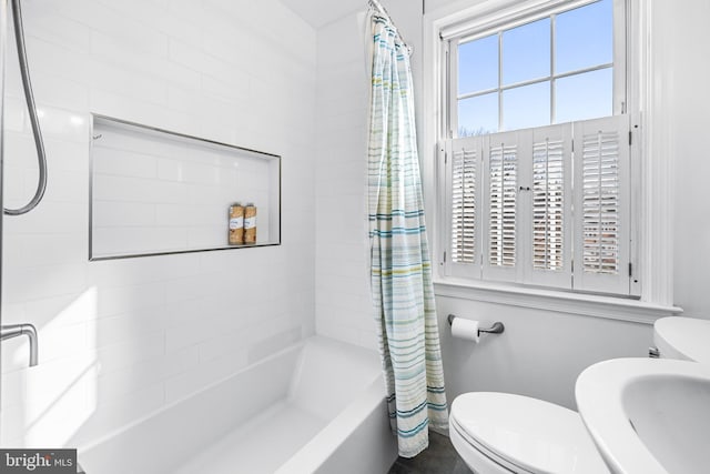 full bathroom featuring sink, shower / bathtub combination with curtain, and toilet