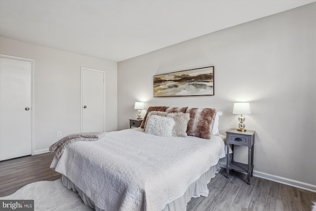 bedroom with wood finished floors and baseboards