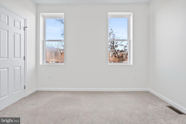 unfurnished room featuring carpet