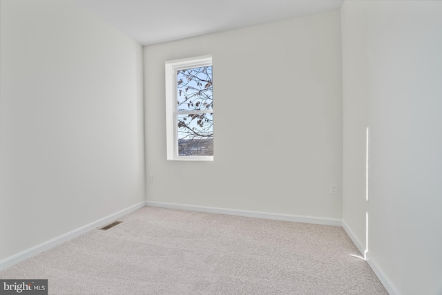 unfurnished room with light colored carpet