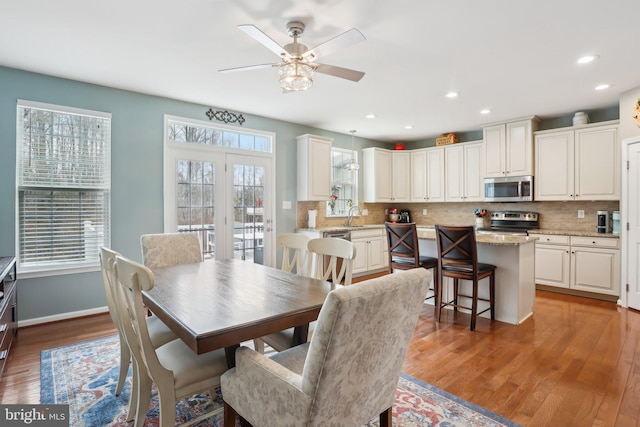 dining area with a ceiling fan, baseboards, wood finished floors, and recessed lighting