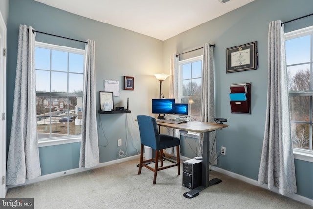 office space featuring carpet floors, visible vents, and baseboards