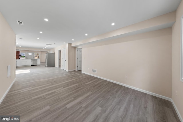 unfurnished living room with visible vents, recessed lighting, light wood-style floors, and baseboards