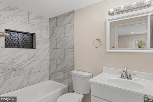 bathroom featuring vanity, toilet, and tub / shower combination