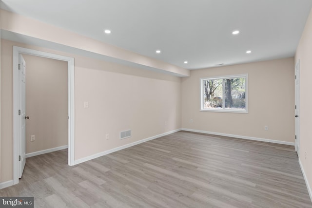 empty room with recessed lighting, visible vents, baseboards, and wood finished floors