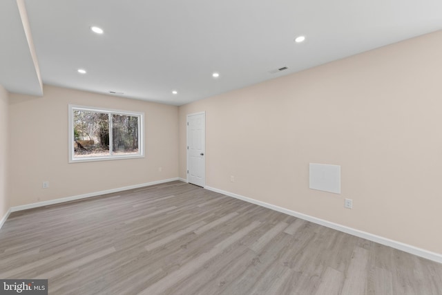 spare room featuring recessed lighting, baseboards, and light wood-style floors