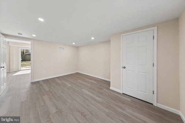 empty room with visible vents, baseboards, and light wood-style floors