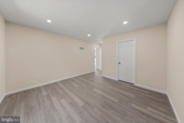 spare room featuring visible vents, recessed lighting, wood finished floors, and baseboards