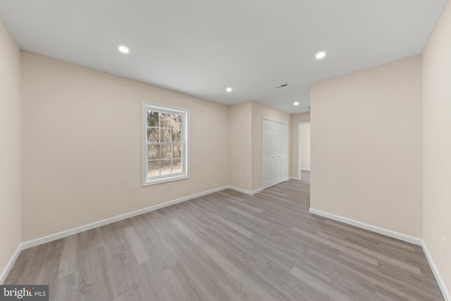 unfurnished room featuring recessed lighting, visible vents, baseboards, and wood finished floors