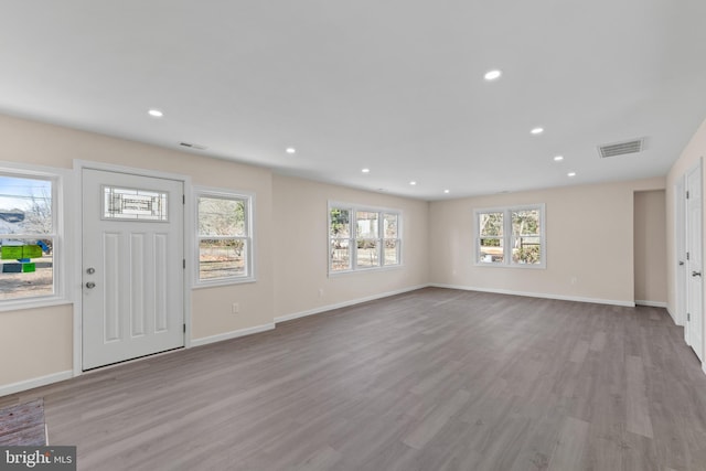 foyer entrance with visible vents, recessed lighting, baseboards, and wood finished floors