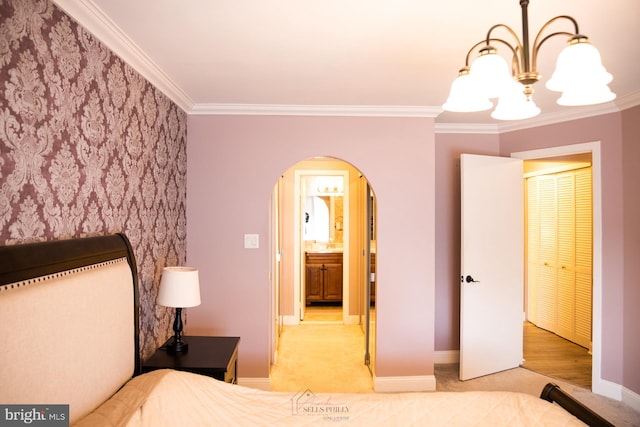 bedroom featuring an inviting chandelier, crown molding, and light colored carpet