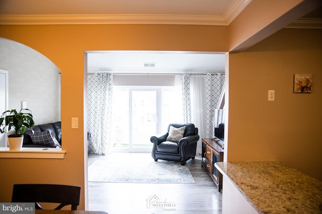 sitting room featuring ornamental molding and dark hardwood / wood-style flooring