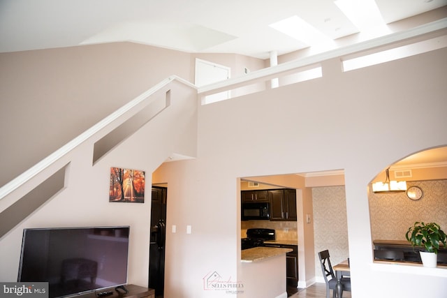 living room featuring lofted ceiling