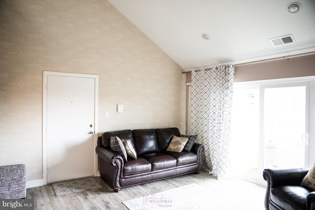 living room with light wood-type flooring and lofted ceiling