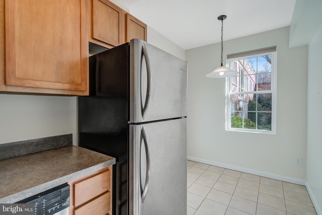 kitchen featuring pendant lighting, stainless steel fridge, dishwashing machine, and light tile patterned floors