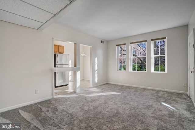 unfurnished living room featuring light carpet