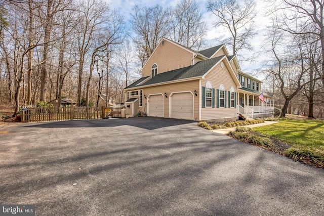 view of property exterior featuring a garage and a lawn