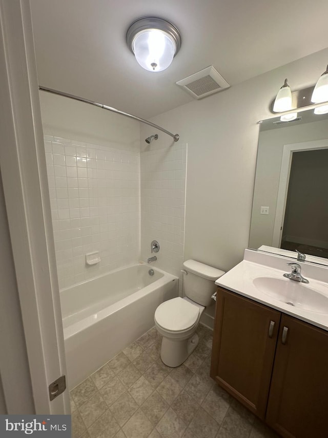 full bathroom with tiled shower / bath, vanity, and toilet