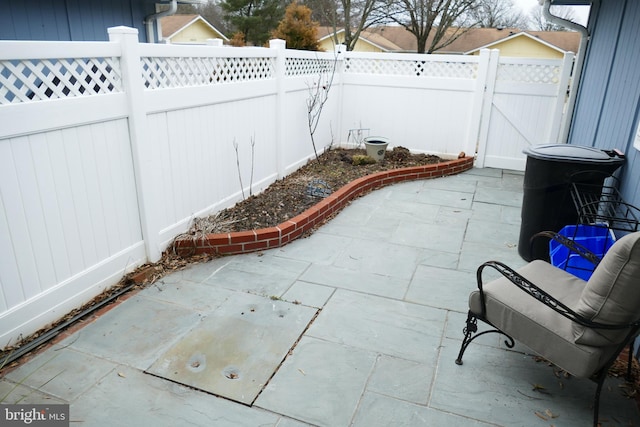 view of patio featuring a fenced backyard and a gate