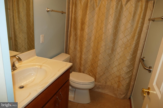 bathroom featuring a shower with shower curtain, toilet, vanity, and tile patterned flooring