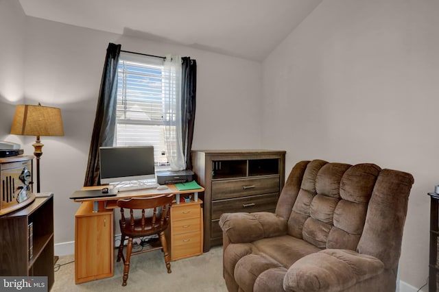 office featuring lofted ceiling and light colored carpet